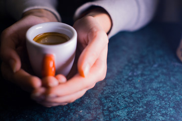 The girl is holding a cup of American coffee.