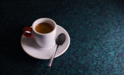 Obraz na płótnie Canvas A cup of coffee is americano on a dark background.