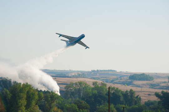 Firefighter airplane extinguishes a forest fire