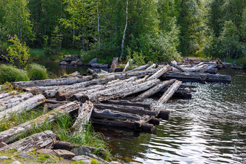 Details of an old wooden destroyed bridge across the river