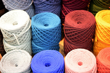 Colorful Balls Of Wool On Shelves. Variety of knitting yarns. Different Yarn balls in multiple colors. Yarn Storage.