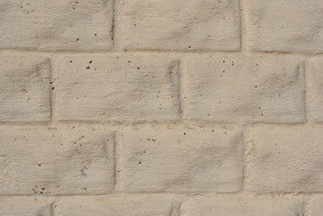 The sand-colored plaster on the brick, grunge texture background
