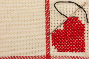 heart embroidered in cross stitch on canvas