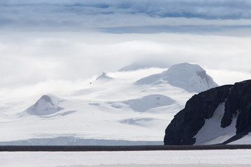 Wind and clouds sweep over this mountain in Antarctica.