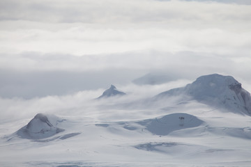 Wind and clouds sweep over this mountain in Antarctica.