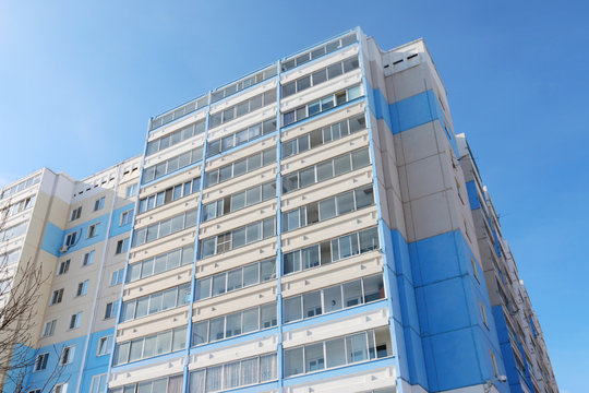New multi-storey residential building on background of blue sky