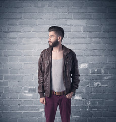 Fashion model in front of brick urban wall