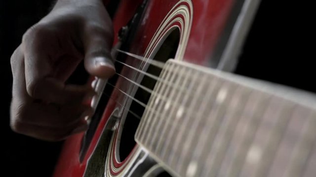 Acoustic guitar in musician hands