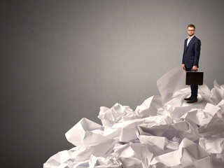 Businessman standing on crumpled paper