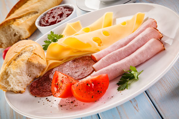 Breakfast - sausages, yellow cheese and vegetables 