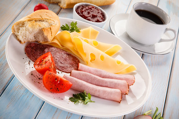 Breakfast - sausages, yellow cheese and vegetables 