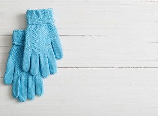 blue gloves on white wooden background