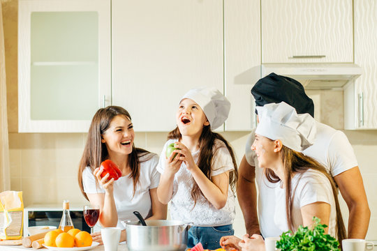 Shocked daughter cooking at kitchen. Surprised family at kitchen