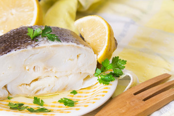dish with cod fillet in olive oil and lemon