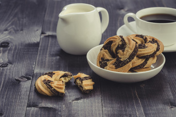 cookies and coffee on a wooden dark backgroundcookies and coffee on a wooden dark background. Top view/cookies and coffee on a wooden dark background. Toned
