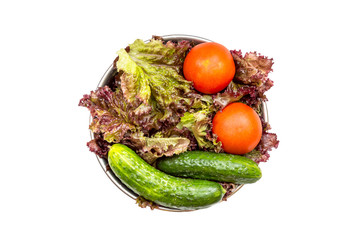 Bowl with ingredient for salad - fresh lettuce, tomatoes, cucumbers. Top view. Isolated on white.