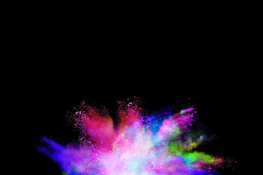 Splash of colorful powder over black background. © piyaphong