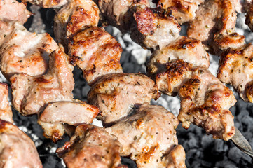 Shashlik prepares on the mangal. Close up.