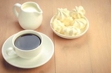 cup of coffee, creamer and meringue/cup of coffee, creamer and meringue with copy space