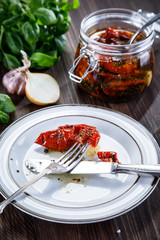 Dried tomatoes on wooden background