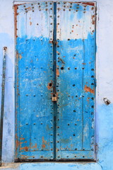 Old blue door of a house in Chaouen, Morocco