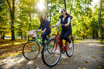 Healthy lifestyle - people riding bicycles in city park