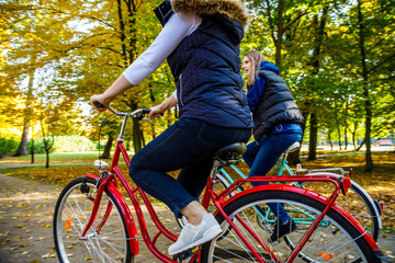 Healthy lifestyle - people riding bicycles in city park