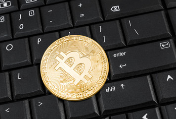Bitcoin on computer keyboard. Close up. Business concept.