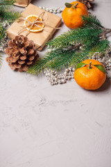 Fototapeta na wymiar Christmas presents and oranges on grey stone background