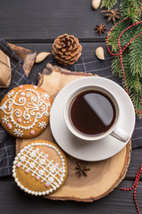 Cup of black coffee with Christmas gingerbread cookies on black 