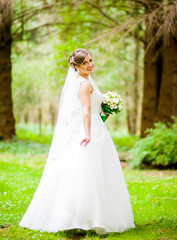 Fototapeta na wymiar Dreamy bride holds green bouquet