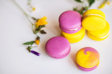 Symbol heart of flowers and macaroons on the light background. Top view. Text I love you