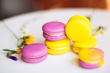 Symbol heart of flowers and macaroons on the light background. Top view. Text I love you