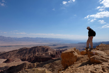 Alone female hiker on scenic mountain landscape..