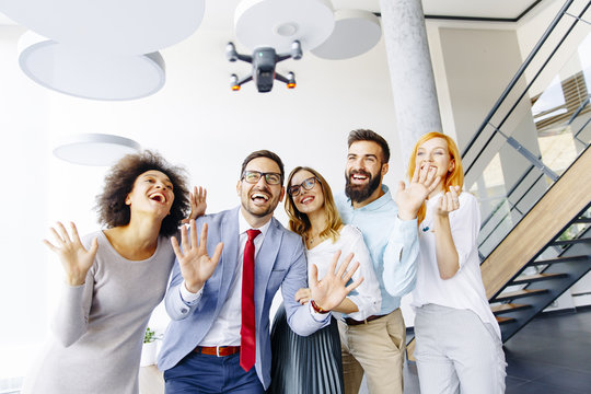 Young Business People  Letting The Drone Camera To Fly Over The Office