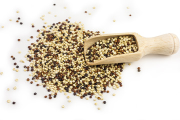 white and brown quinoa seeds on wooden scoop