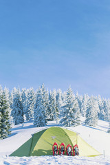 The tent stands on a mountainside in the snow.