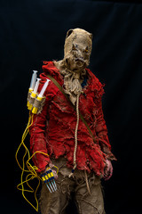 An evil character at the Cosplay Festival, a bag on his head, a hanger and syringes as a weapon. The idea for Halloween