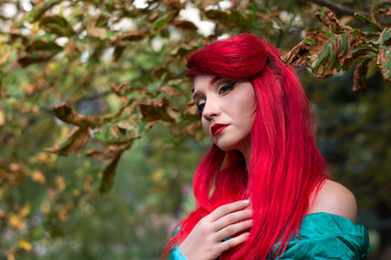 Beautiful girl in a lush dress in the autumn forest. Cosplay Festival, Ariel mermaid