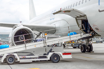 Passenger aircraft loading of baggage into the cargo bay at the airport.