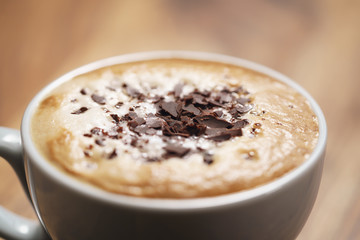 fresh cappuccino with chocolate flakes on wood table
