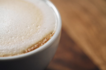 closeup fresh cappuccino with chocolate flakes on wood table