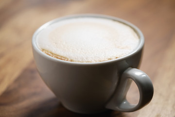fresh cappuccino with chocolate flakes on wood table