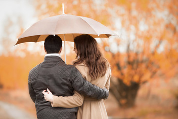 Couple of lovers kissing in the rain