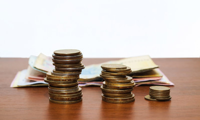 The Ukrainian money - three rouleaux and paper hryvnias against.