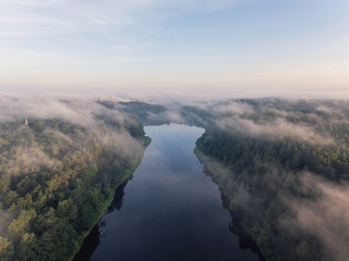 Early morning aerial view over city Druskininkai, Lithuania. City cover in summer fog clouds.