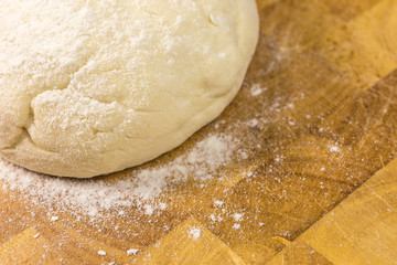ball of pizza dough with dusting of flour