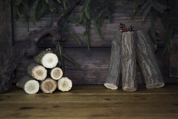 Christmas Background With Pine Branches and Wood logs Against Rustic Wooden Boards