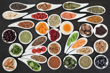 Super foods to boost brain power on slate background. Health food concept high in omega 3 fatty acids, vitamins, minerals, antioxidants and anthocyanins. Top view.