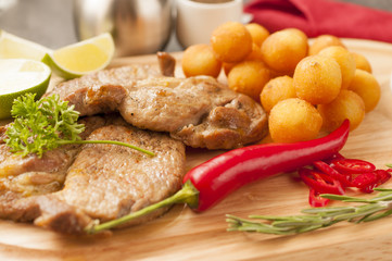 Croquettes with pork served on a wooden tray